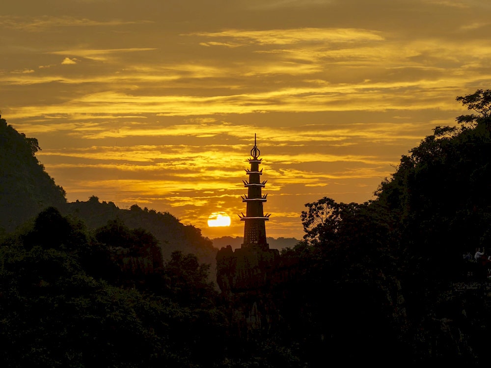 Golden hour magic: Watch the sun melt behind Ninh Binh’s limestone mountains from the summit